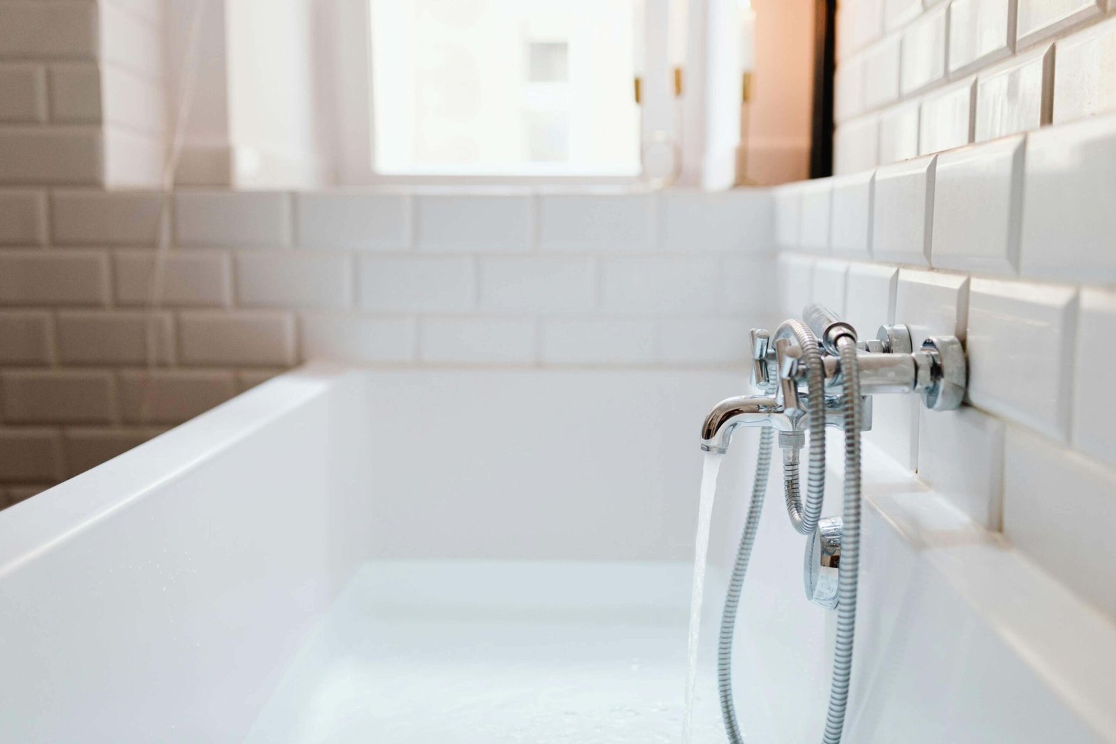 Bath faucet running with water.