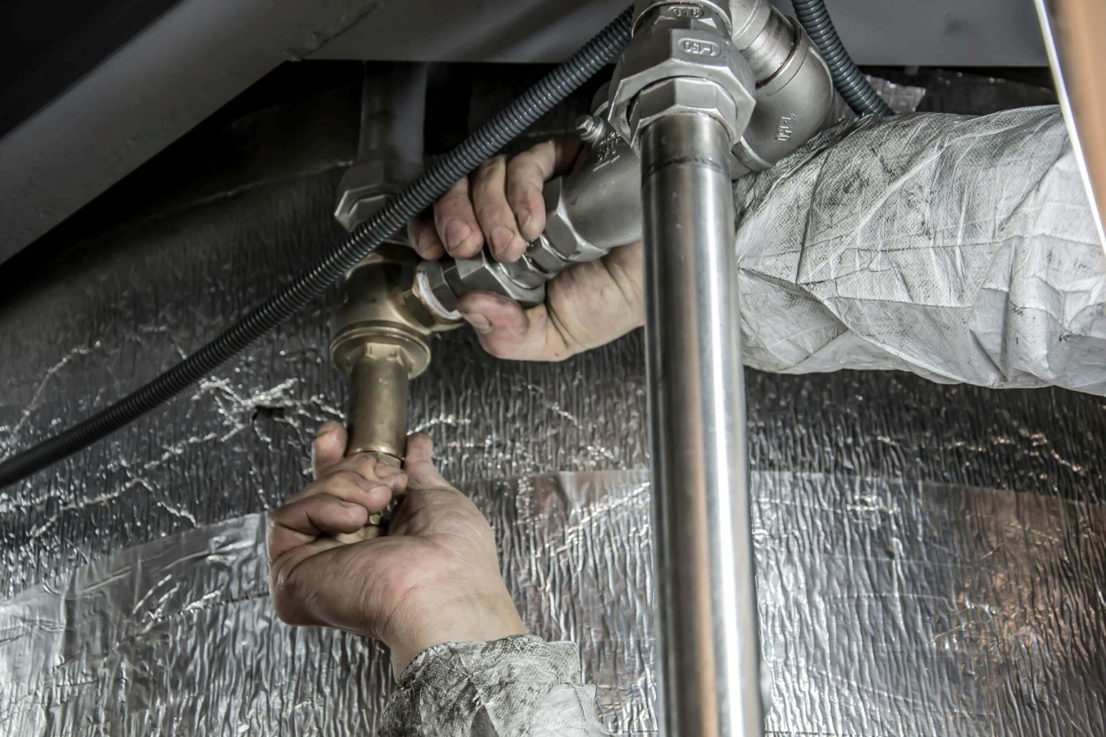 Man fixing pipework.