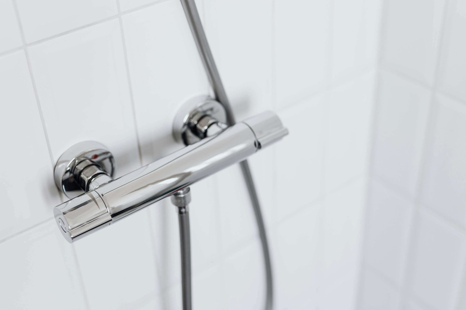 Silver shower outlet and cable.
