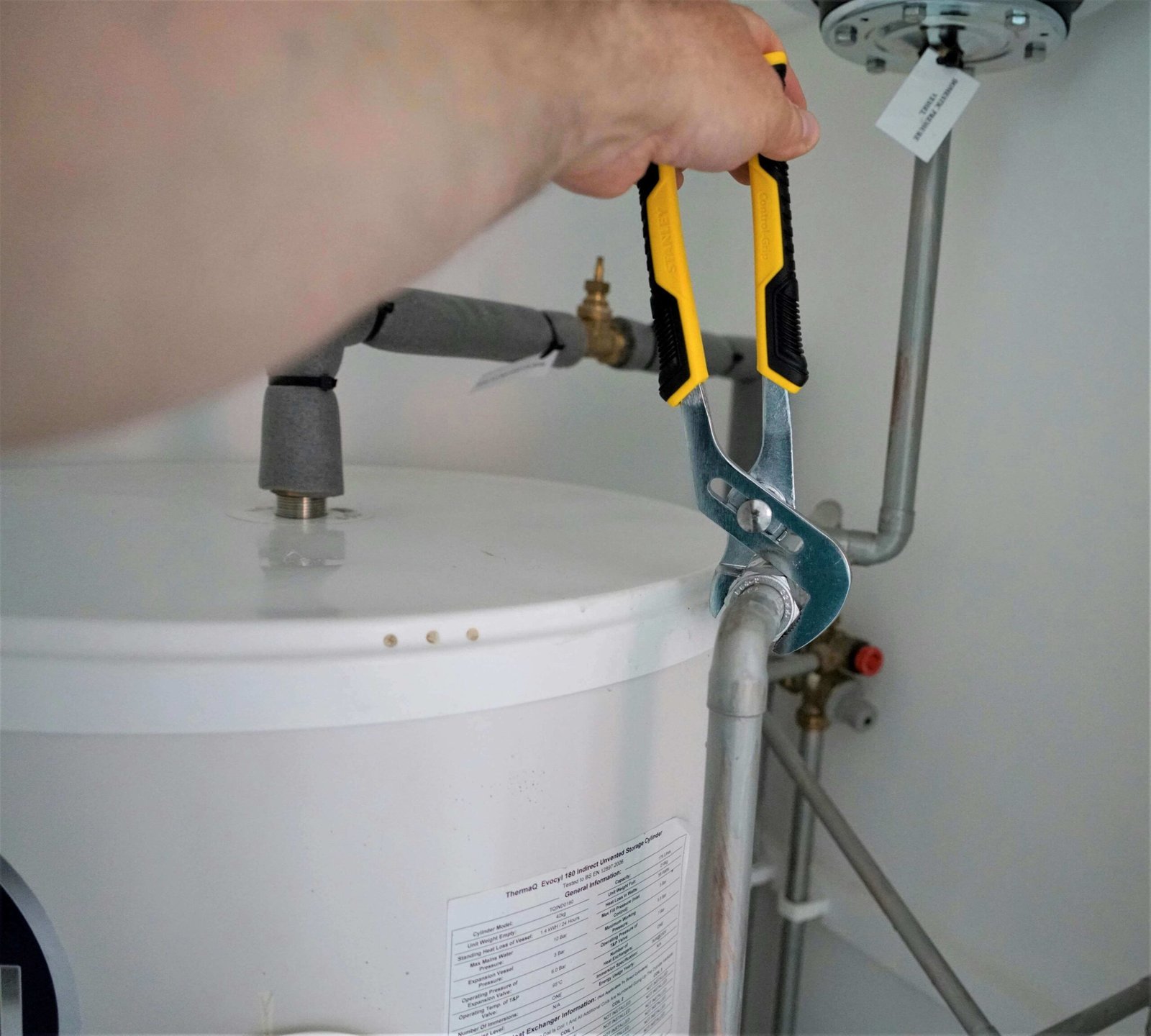 A plumber using a tool to repair a pipe